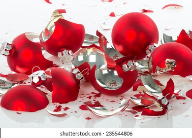 Red broken Christmas balls over a white background