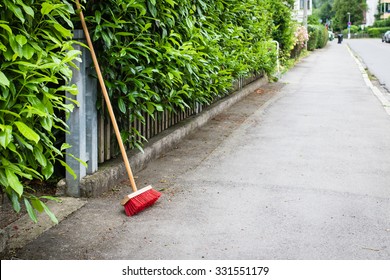 Red Broom On Clean Street In Little German Town, Selective Focus