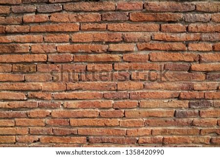 Red brown ancient old vintage brick block wall design pattern texture abstract background. Brick building material in construction site or interior decoration.