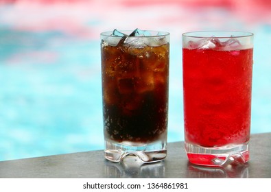 Red And Brown Color Softdrinks At The Poolside