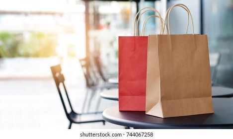 Red and brown shopping bags on tables at front mall store background, business, retail, banner concept
 - Powered by Shutterstock