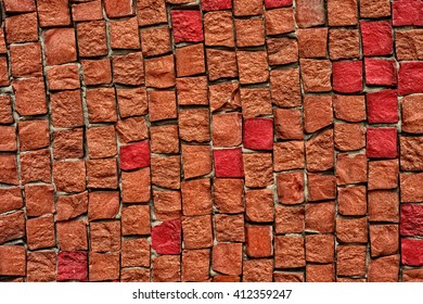 Red and brown smalt mosaic on the wall background.