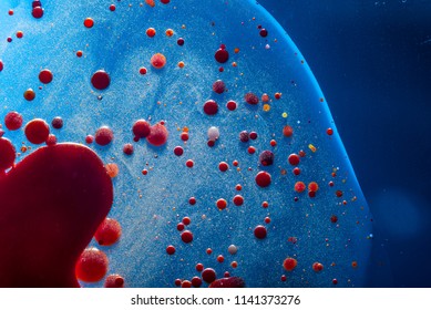 Red bubbles of blood cells on a blue background closeup. Abstraction of medicine and science. The concept of micro processes and diseases in the human body