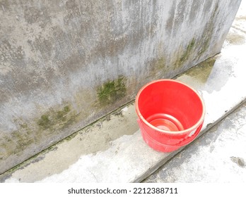 The Red Bucket On The Floor Near The Water Tank