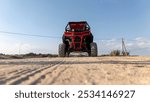 Red buggy on the sand