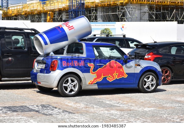 Red Bull\
Mini Cooper car with logo. Giant Red Bull energy drink can on the\
car\'s roof. WARSAW, POLAND - MAY 15,\
2021