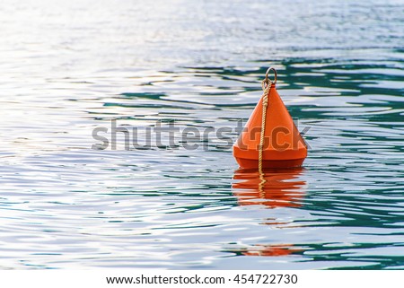 Red buoy on the sea waves background