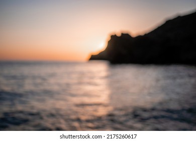 A red burning sunset over the sea with rocky volcanic cliff. Abstract nature summer or spring ocean sea background. - Shutterstock ID 2175260617