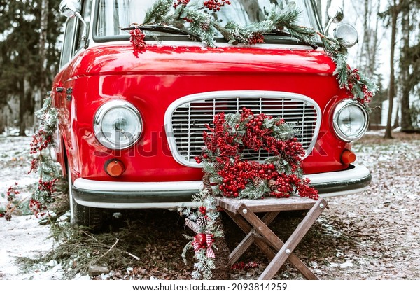 red\
bus decorated with Christmas wreath, blankets, pillows and gift\
boxes with presents is standing in forest, Santa Claus\'s magic\
transport, New Year and Christmas banner\
background