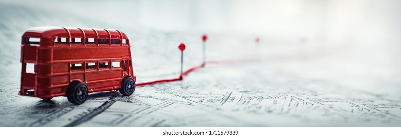 Red bus, pins and route laid on a map of the city. Concept on the  adventure, discovery, navigation, communication, logistics, geography, transport and travel topics. - Shutterstock ID 1711579339