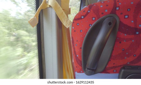 Red Bus Seat. The Bus Is Running And Window Of The Bus Is A Natural View.