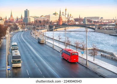 Red bus "Unforgettable Moscow" on the Prechistenskaya embankment of the Moscow River and a view of the Kremlin, Moscow - Shutterstock ID 2240040543