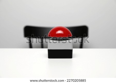 Red button of nuclear weapon on white table. War concept