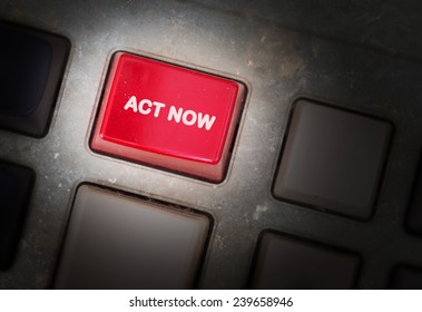 Red button on a dirty old panel, selective focus - act now