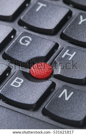 Red button pointing stick trackpoint on keyboard