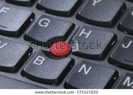 Red button pointing stick trackpoint on keyboard