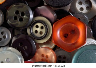 Red Button surrounded by an assortment of other color and size buttons