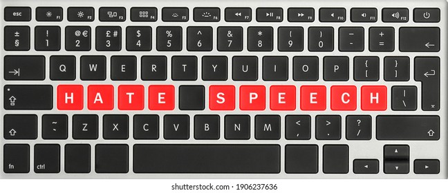 Red buttons with text Hate Speech on computer keyboard, top view