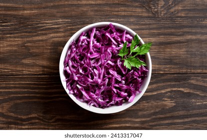 Red cabbage in bowl over wooden background. Top view, flat lay - Powered by Shutterstock