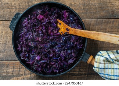 Red cabbage are pan-fried until lightly charred, then braised in mulled wine. Background of fry blue cabbage in a section, macro. Close up, top view. Texture and pattern of purple cabbage