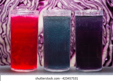 Red cabbage pH indicator solution. Acidic lemon juice (red), alkali sodium bicarbonate (blue) and neutral tap water (purple) showing property of anthocyanin in red cabbage juice