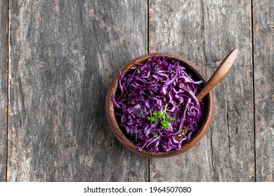 Red cabbage  salad in wooden bowl on rustic wooden table  - Powered by Shutterstock