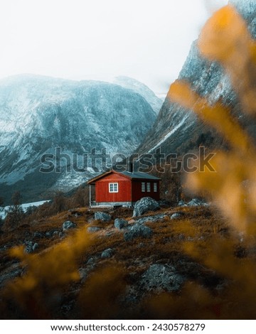 A Red Cabin In The Mountains In Norway 
