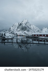 Red Cabins On A Snowy Reine In Moskenesøya Island, Norway