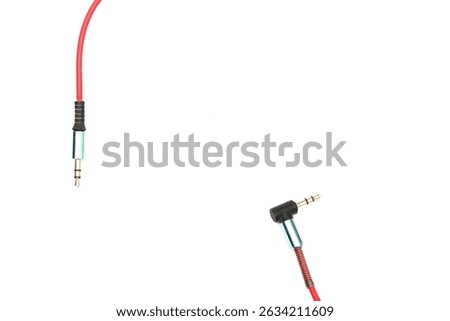 red cable 3.5mm audio jack isolated on white background. cable aux wire isolated on white. Plug of headphone for smartphone on isolated white background.
