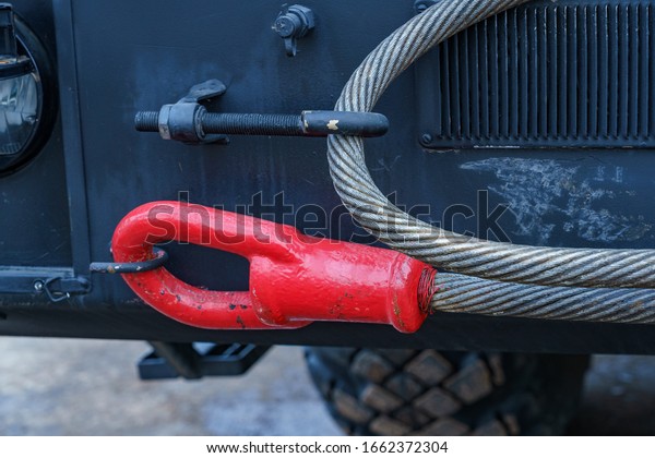 red cable end for towing military equipment mounted\
on a car