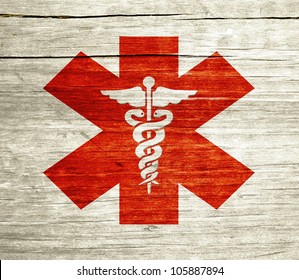 Red Caduceus on wood with grunge design