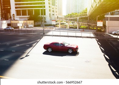 Red camaro drives along the empty highway somewhere in Dubai