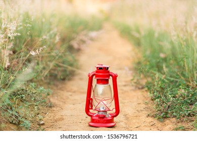 Red Camping Lantern Left On The Ground