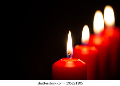 Red candles with black background - Powered by Shutterstock