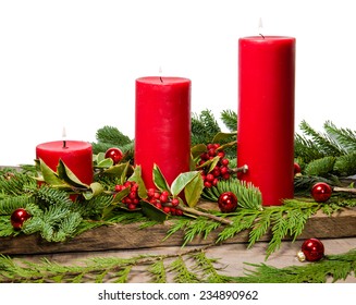 Red Candles In A Centerpiece Of Boughs