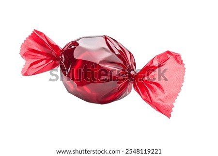 Red candy in a wrapper isolated on white background