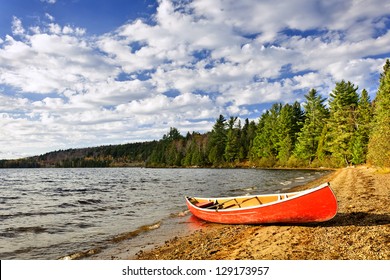 Red Canoe On Beach At Lake Of Two Rivers, Ontario, Canada