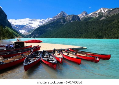 Red canoes in the blue waters of Lake Louise, Banff National Park, Alberta, Canada