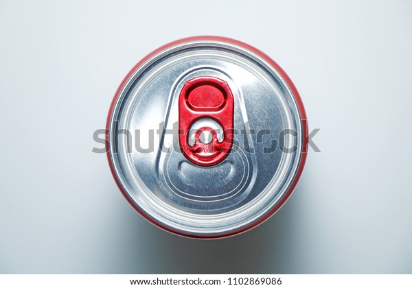 Red cans with a carbonated drink on a white\
background. View from above
