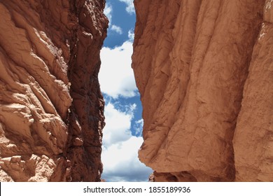 The red canyon. Natural texture and pattern. View of the sky between the red sandstone and rocky cliffs in the desert of Quebrada de las Conchas in Salta, Argentina.
