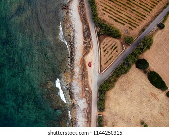 Red Car From Above On Driveway Next To The Sea