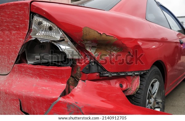 The red car after the accident, broken right taillight\
close-up. Car crash - accident and insurance. Car accident closeup.\
