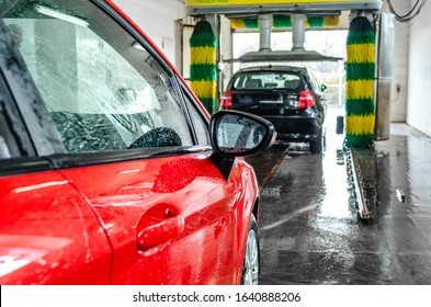 Red Car At An Automatic Car Wash.