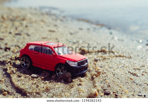 red car by the sea on the sand, a trip
to the sea by car rest on private
transport