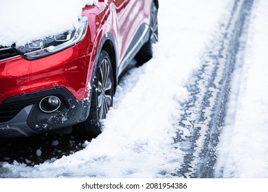 Red Car Covered In Snow. Winter Morning. Snowy Road.