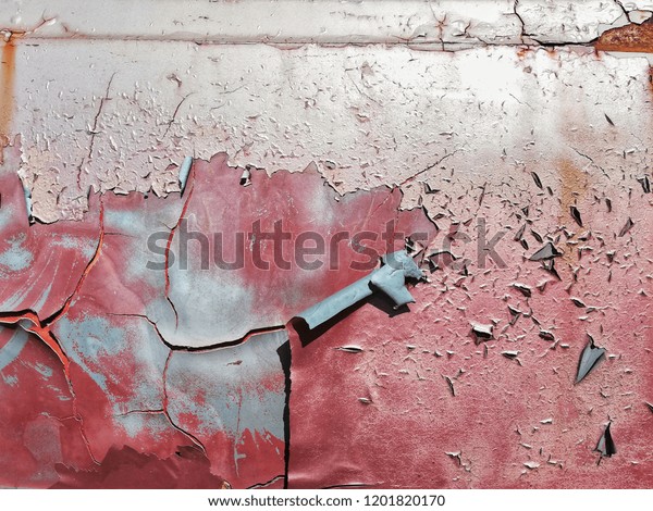 Red car door\
peeling out because it is very\
old.