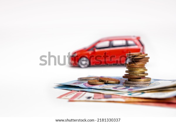 red car, euro banknotes\
and coins isolated on white background with clipping path,\
insurance concept