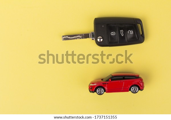 Red car and\
key. Concept of the automobile loan, saving money for car, trade\
car for cash, the concept of\
Finance.