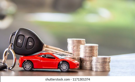 red car  and key on stacks of coin,  car loan concept,  Saving money for car concept,  trade car for cash concept, finance concept.