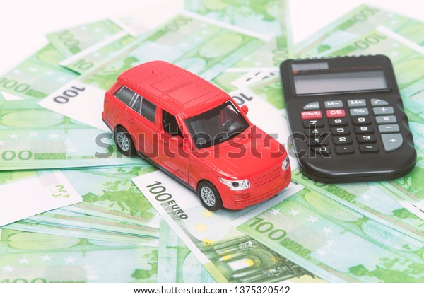 red
car and money, euro and dollars. insurance
concept
